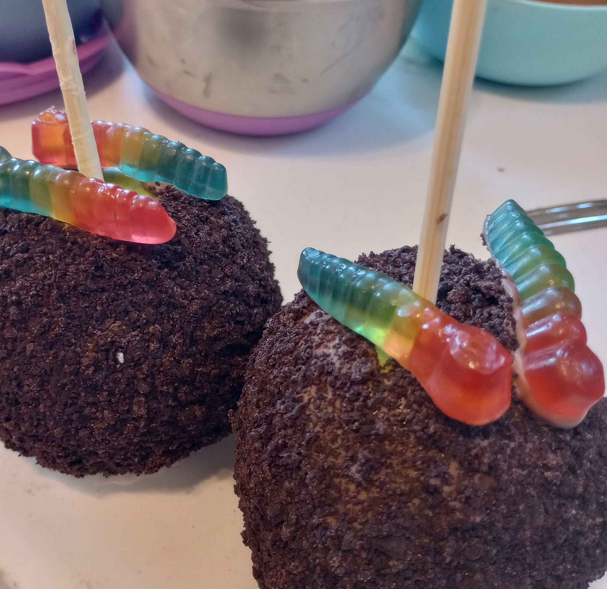 cookie crumble covered caramel apples with gummy worms